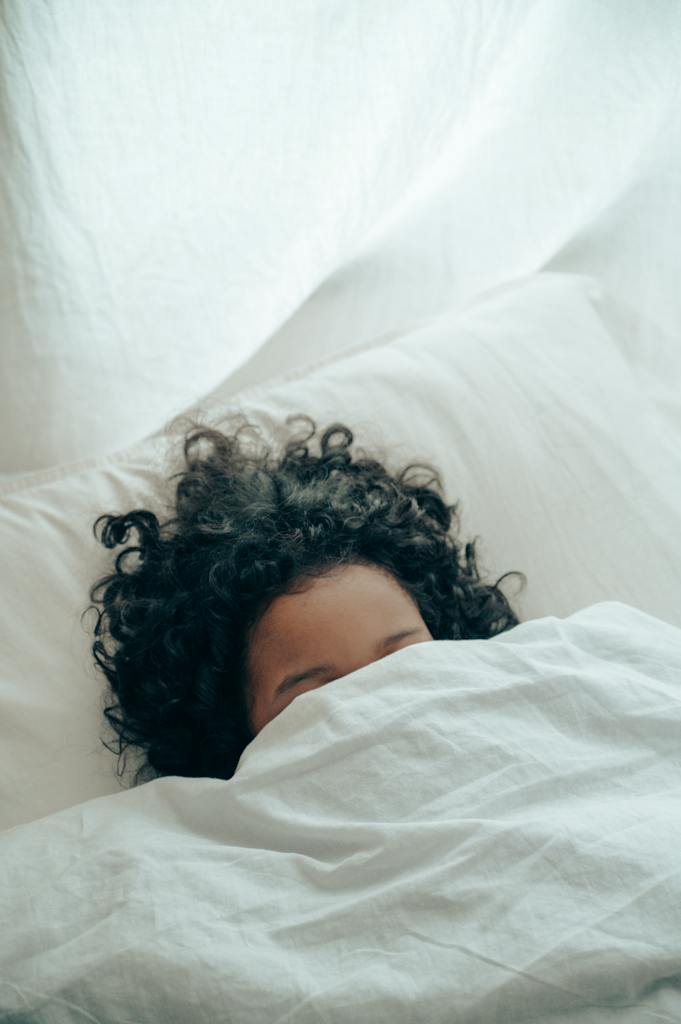 Person sleeping under blanket