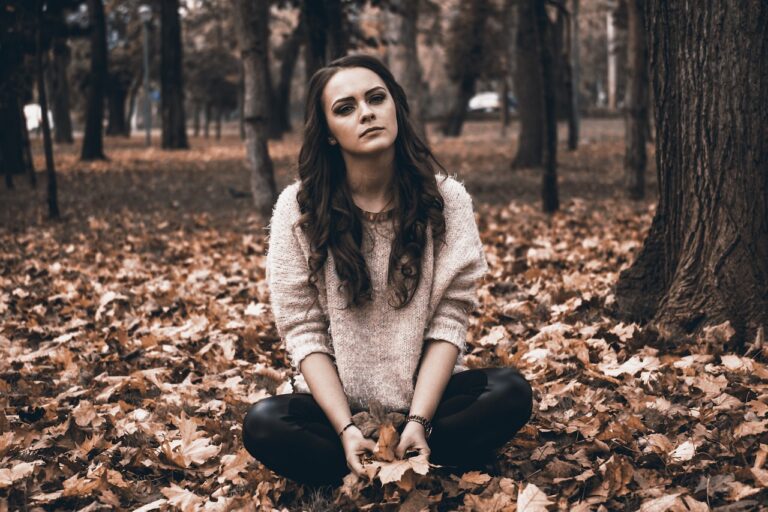 A woman sitting in the leaves