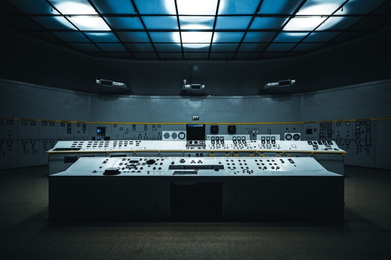 A large control room with many switches and a large ceiling