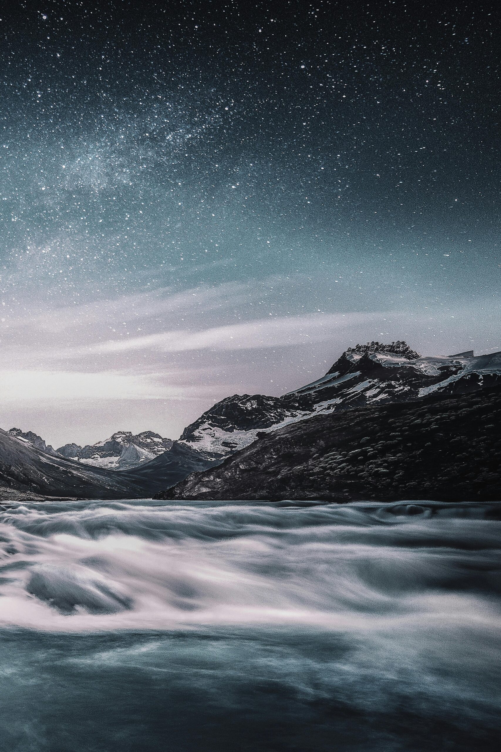 A foggy mountain landscape with mountains and stars