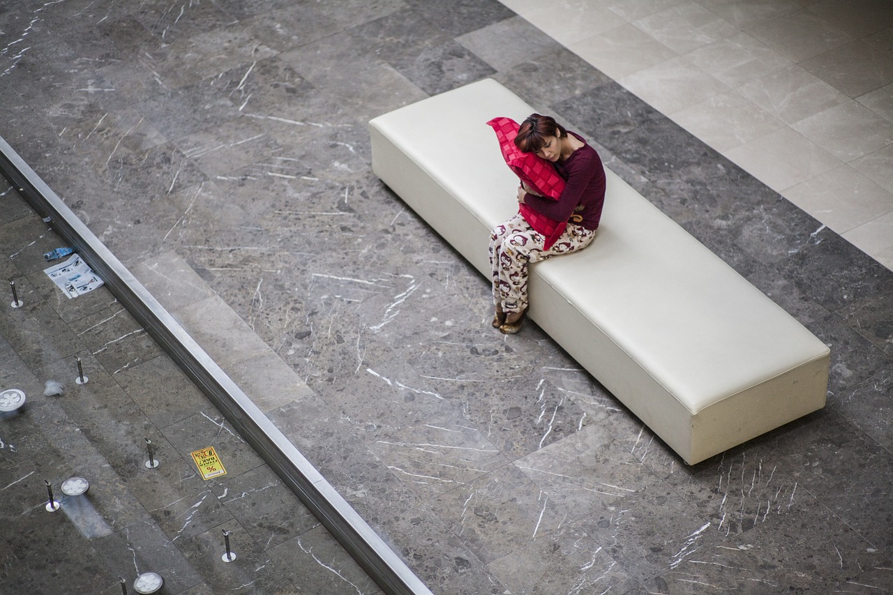 A woman sitting on a white bench