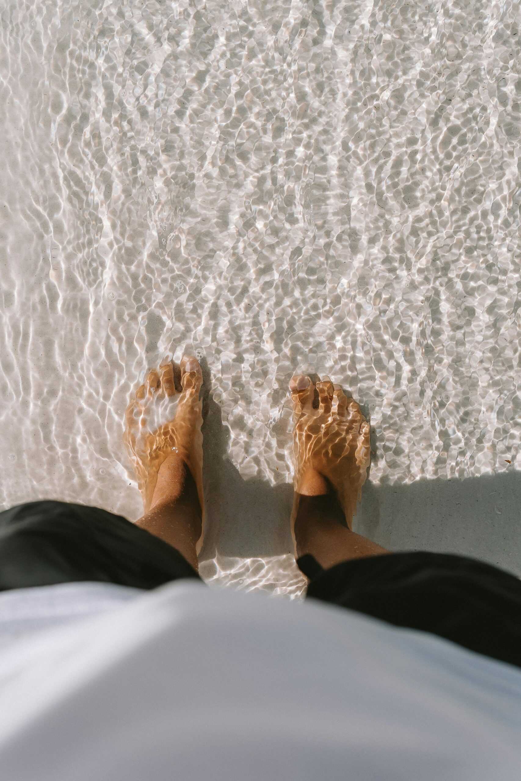 A person's feet in water