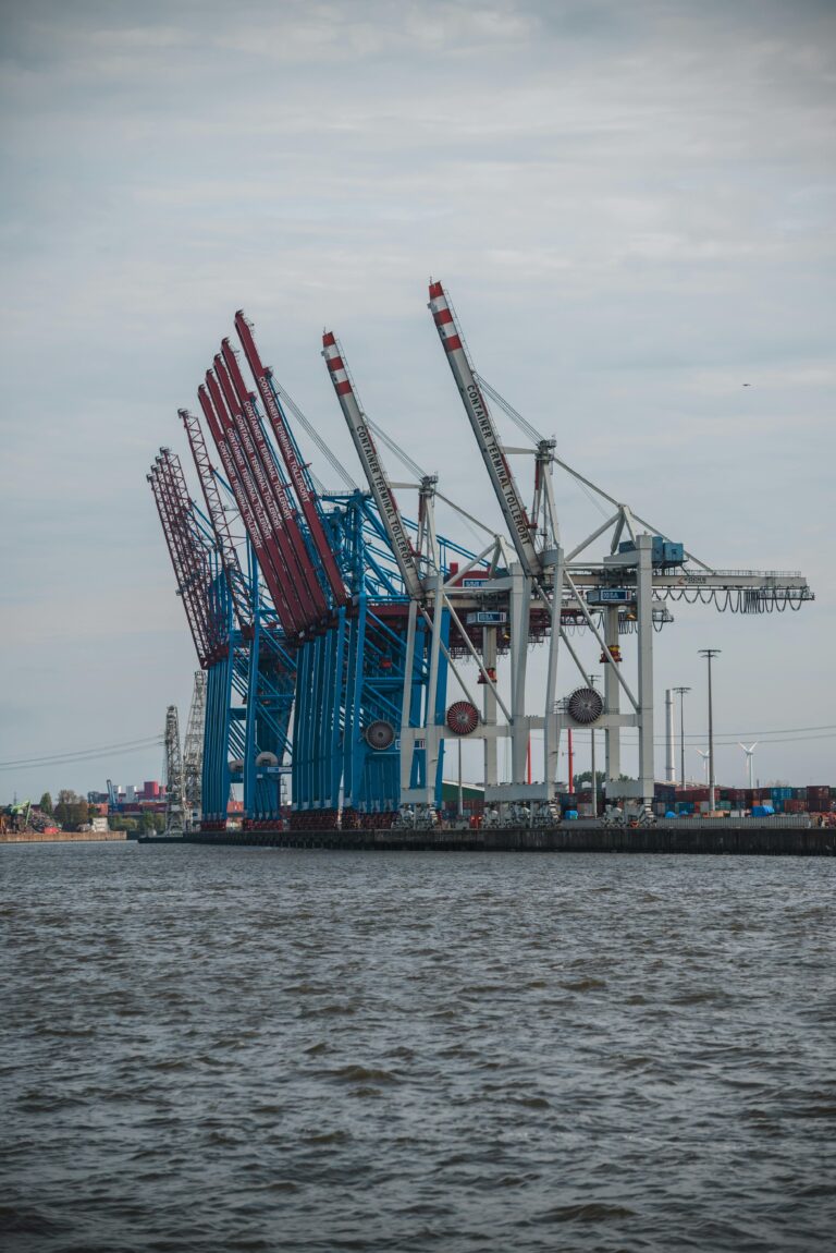 A large metal structure with cranes on a body of water